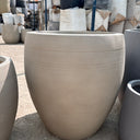 Fiber Luna Patterned Pots Lifetime Warranty in the UAE. Beige outdoor chair with textured surface on a concrete floor