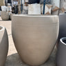 Fiber Luna Patterned Pots Lifetime Warranty in the UAE. Beige outdoor chair with textured surface on a concrete floor