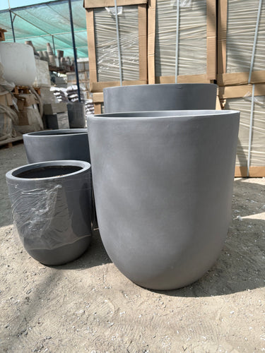 Fiber Pot Aura Grey Lifetime Warranty in the UAE. Metal pipes stacked outdoors on a concrete surface